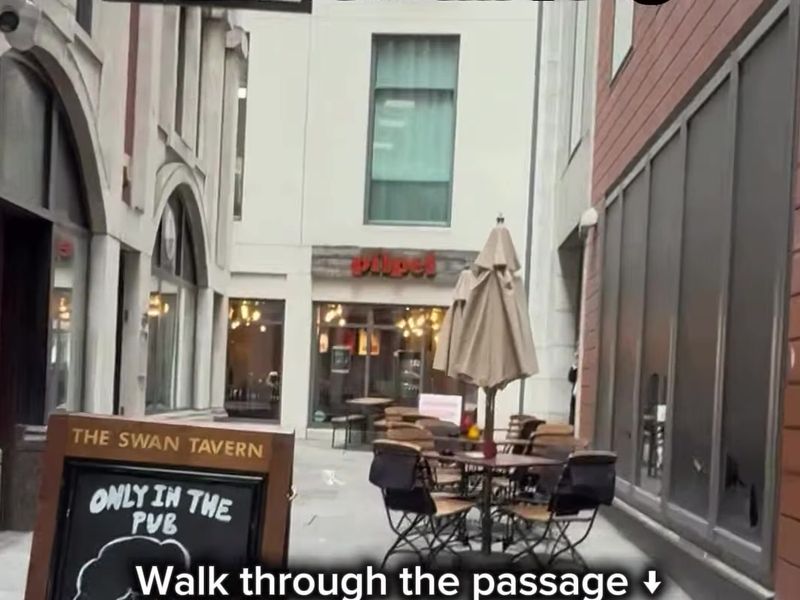 Lime Street Passage with outdoor tables leading to Pilpel